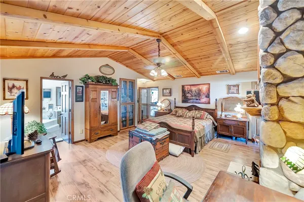 a bedroom with a large bed and a large mirror on the dresser