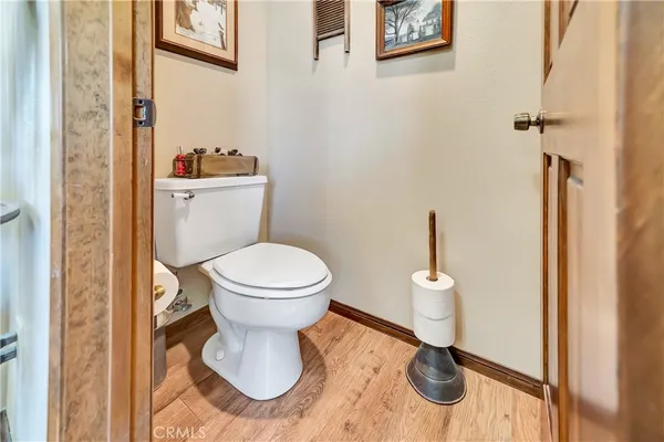 a kitchen with a sink and a stove next to a blue chair