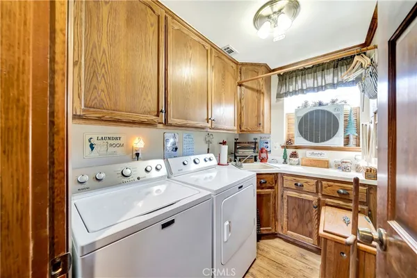 a bathroom with a granite countertop toilet sink and mirror