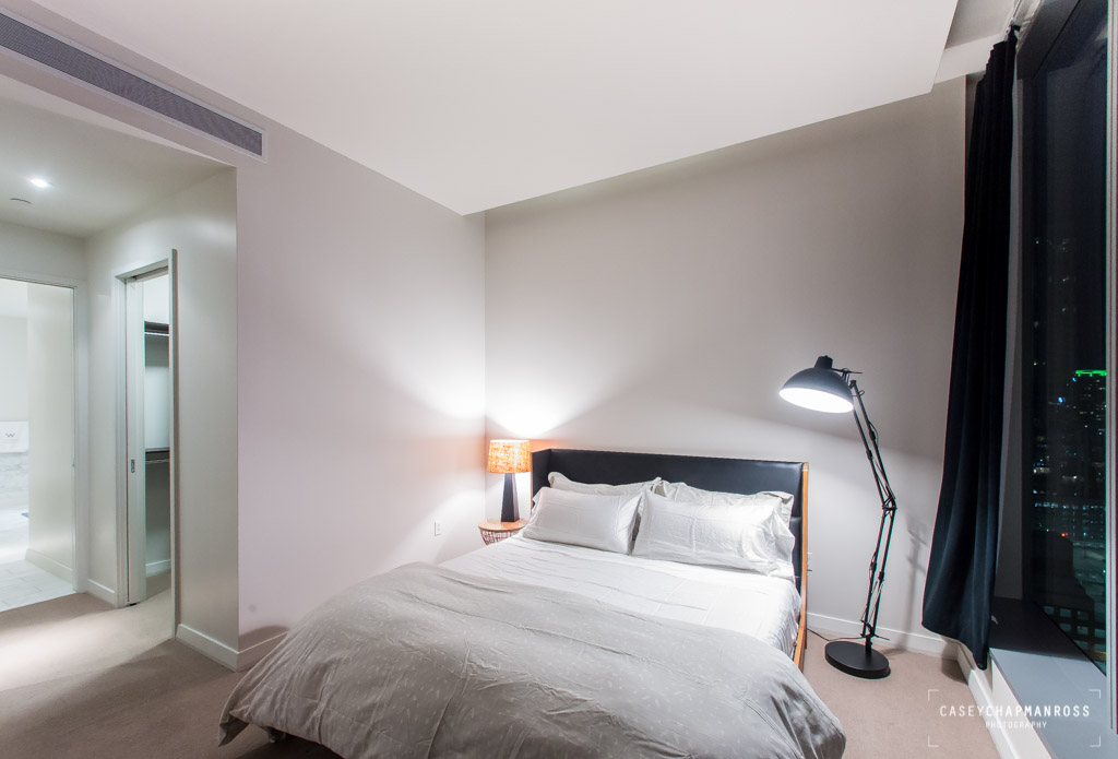 210 Lavaca Street, Unit 1910 Austin, TX 78701 - Photo 27 of 40 a bedroom with a bed and a mirror