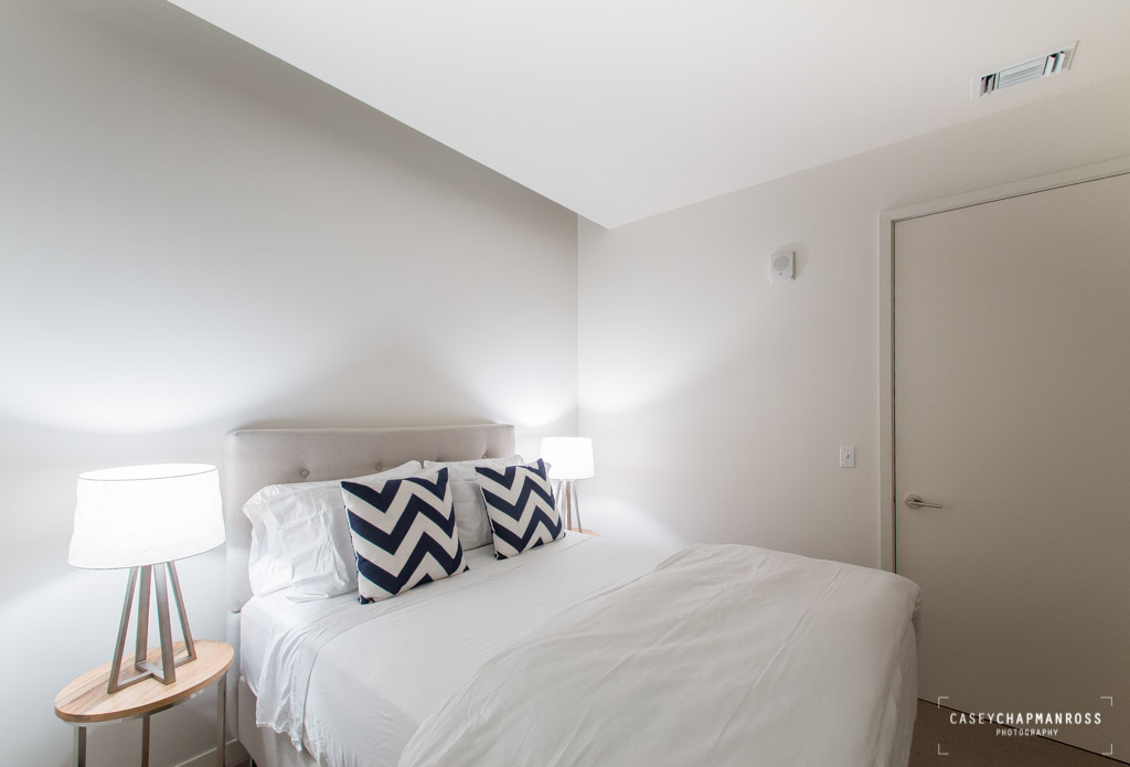 210 Lavaca Street, Unit 1910 Austin, TX 78701 - Photo 39 of 40 a bedroom with a bed and a lamp