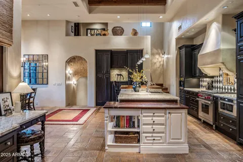 a kitchen with kitchen island stainless steel appliances a sink stove and refrigerator