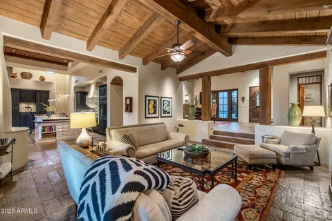 a balcony with wooden floor and outdoor seating