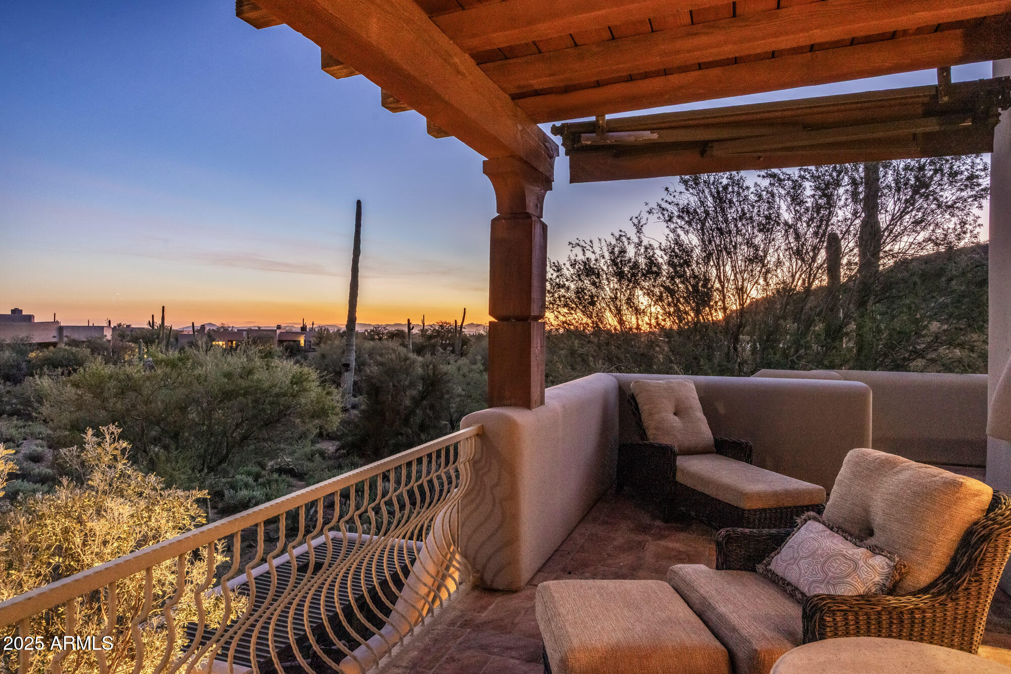 8300 East Dixileta Drive, Unit 211 Scottsdale, AZ 85266 - Photo 23 of 35 a balcony with wooden floor and outdoor seating