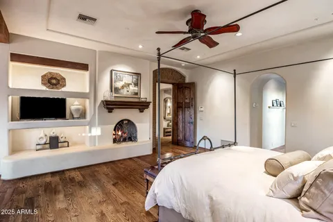 a bedroom with furniture and a wooden floor