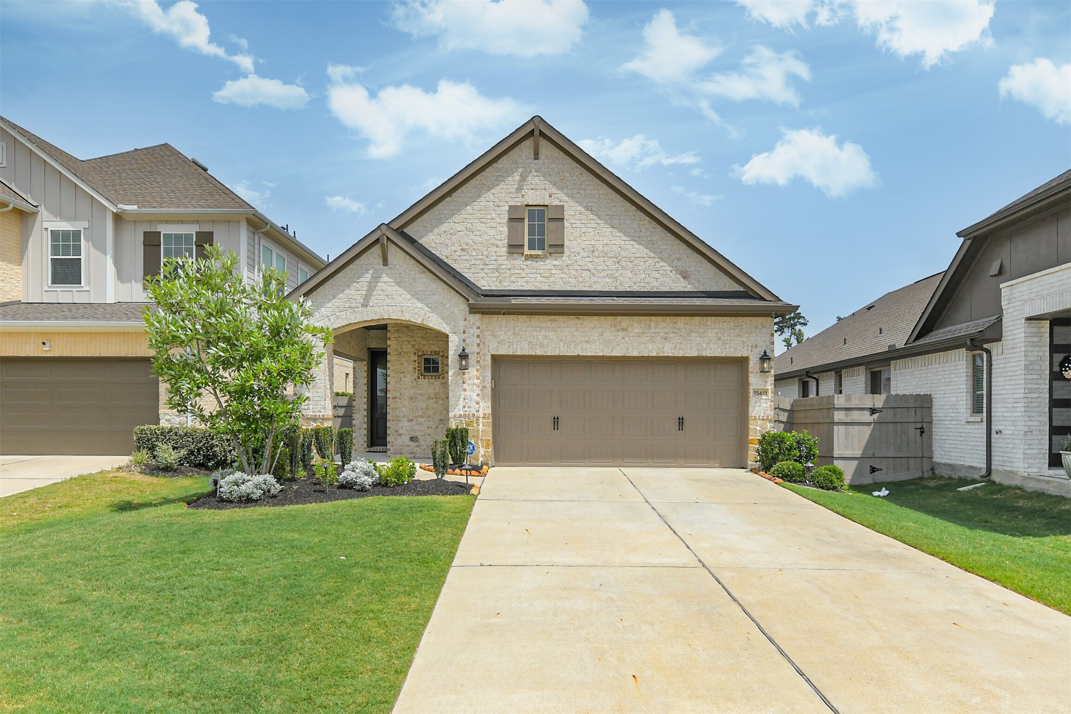 15611 Rising Wren Court Conroe, TX 77302 - Photo 2 of 38 a front view of a house with a yard and garage
