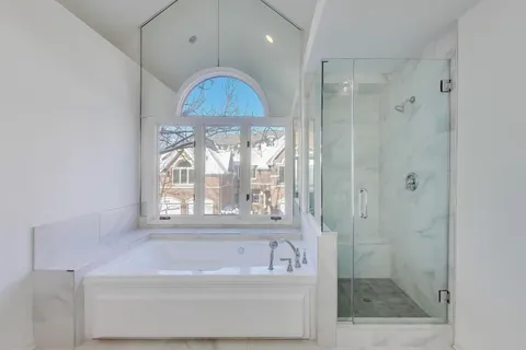 a bathroom with a bathtub a shower and a sink