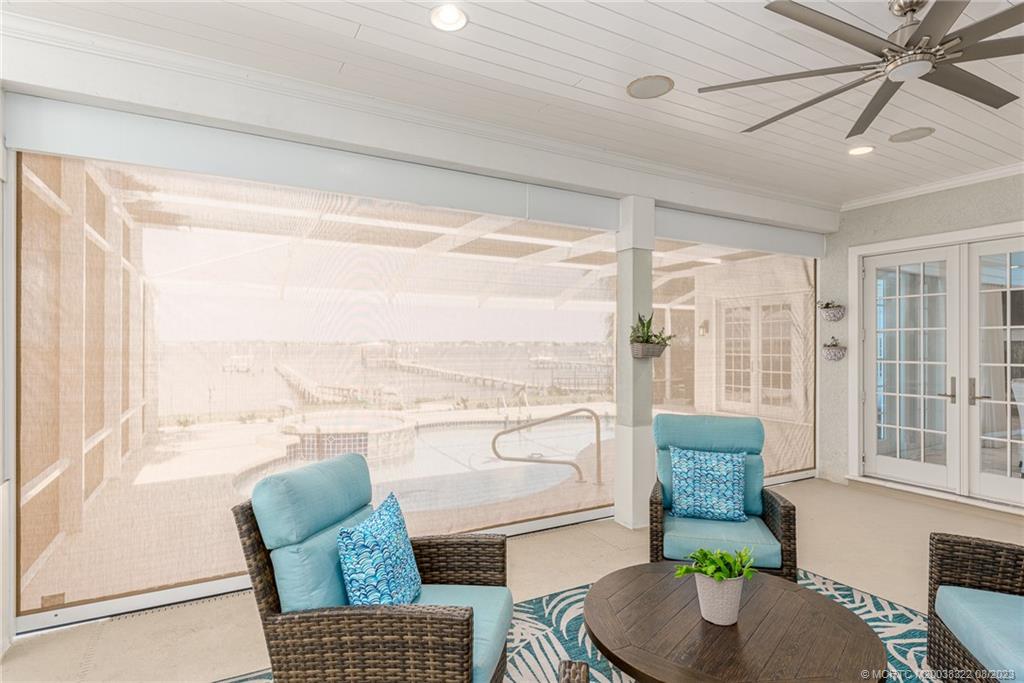 1455 Southeast Riverside Drive Stuart, FL 34996 - Photo 66 of 100 a living room with furniture and a floor to ceiling window
