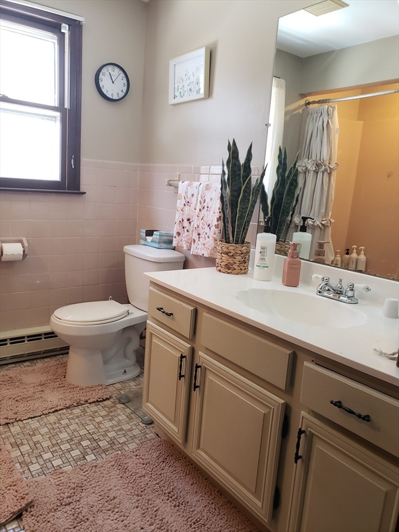 81-83 Motyka Street Ludlow, MA 01056 - Photo 11 of 20 a bathroom with a sink a toilet and mirror