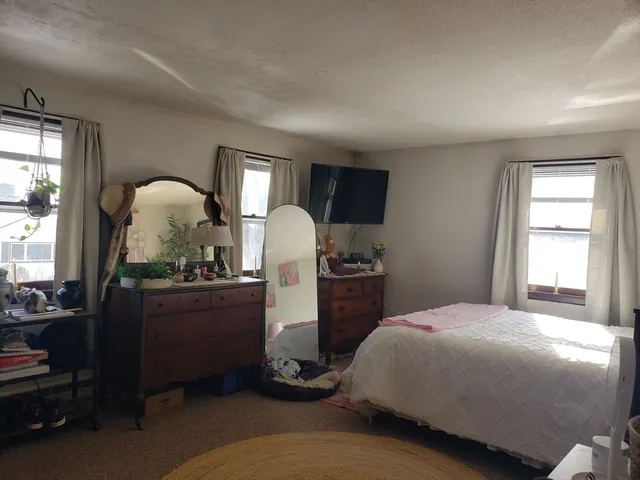 a bed room with furniture and a window