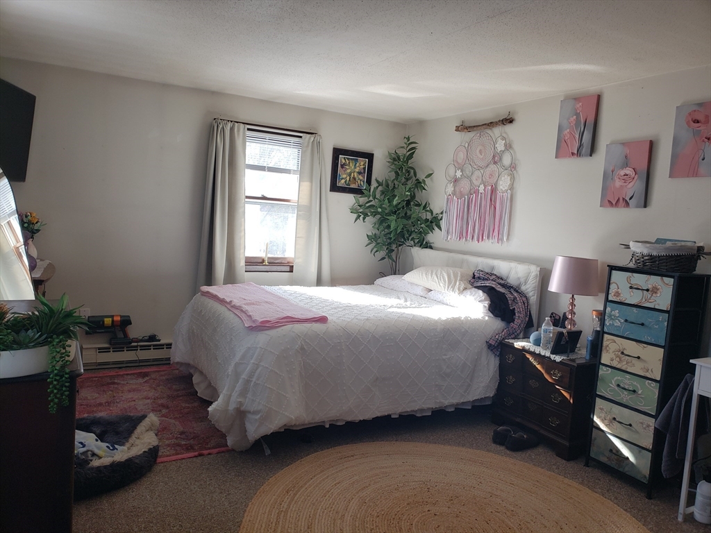 81-83 Motyka Street Ludlow, MA 01056 - Photo 14 of 20 a bedroom with a bed and a window