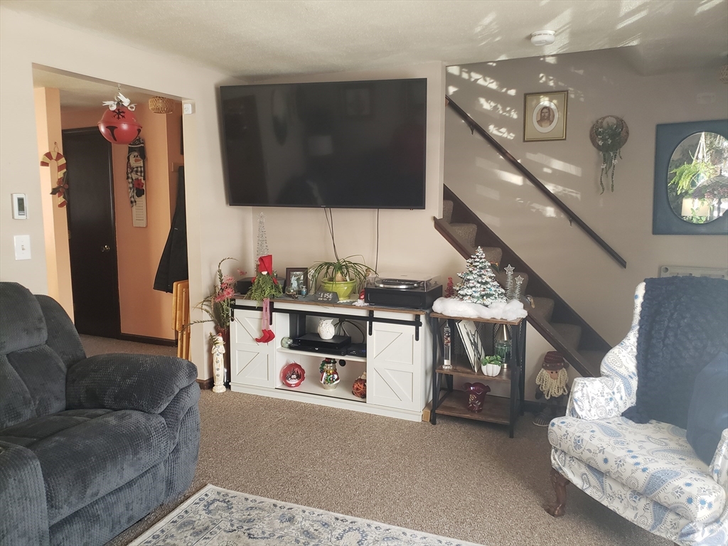 81-83 Motyka Street Ludlow, MA 01056 - Photo 4 of 20 a living room with furniture and a flat screen tv