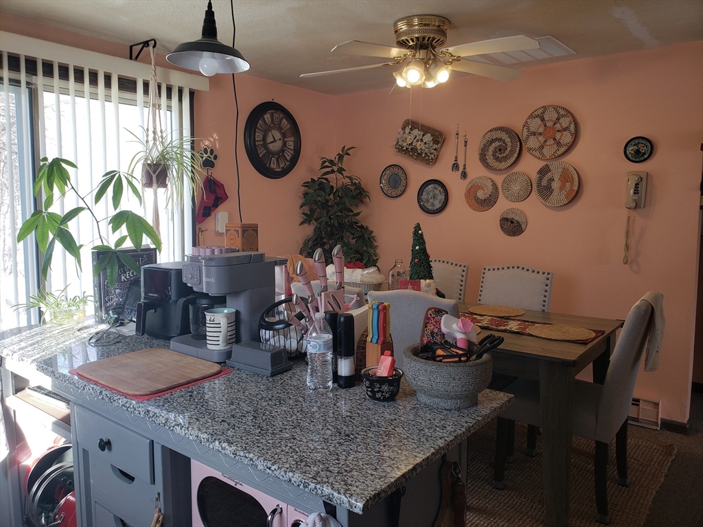 81-83 Motyka Street Ludlow, MA 01056 - Photo 8 of 20 a table with chairs and a clock on it