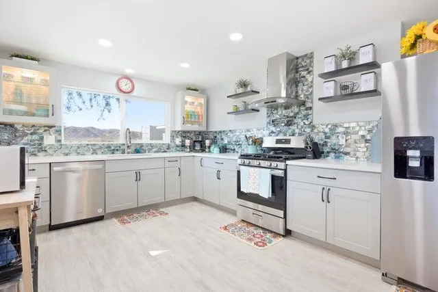 a kitchen with a white cabinets stove and refrigerator