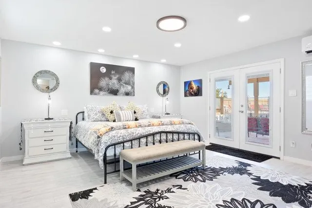 a bedroom with a bed and a painting on the wall