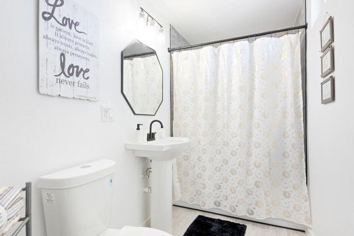 69450 Amboy Road Twentynine Palms, CA 92277 - Photo 17 of 46 a bathroom with a sink a toilet and a mirror