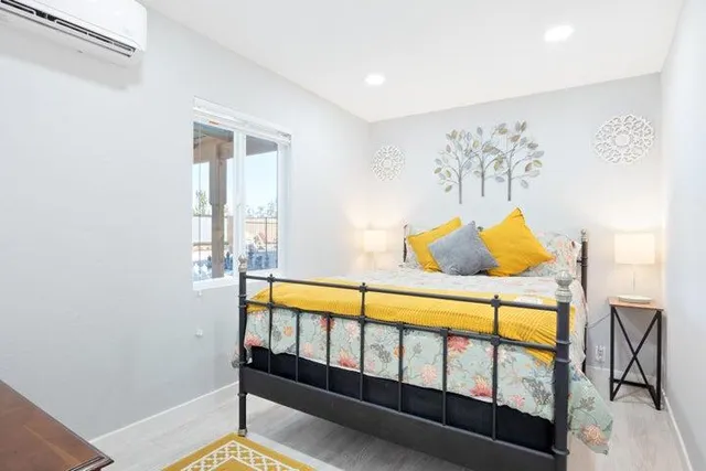 a bedroom with a bed and a window