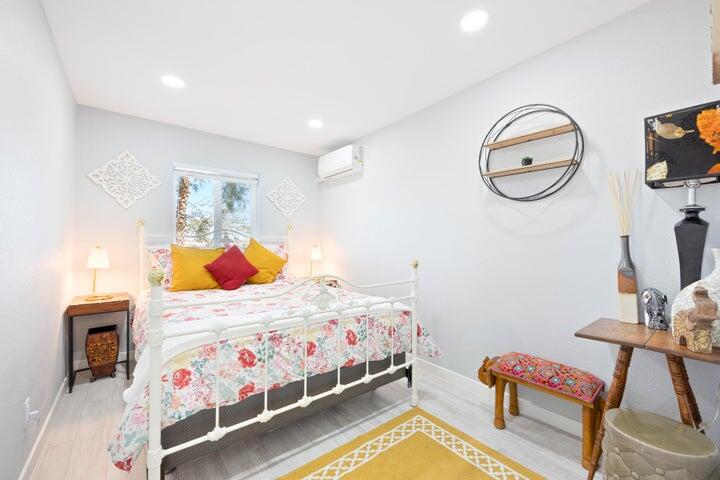 69450 Amboy Road Twentynine Palms, CA 92277 - Photo 20 of 46 a bedroom with a bed and a chandelier