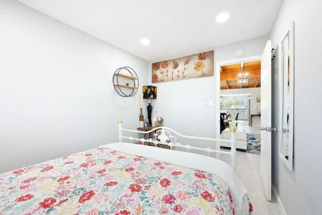 a bedroom with a bed and a mirror