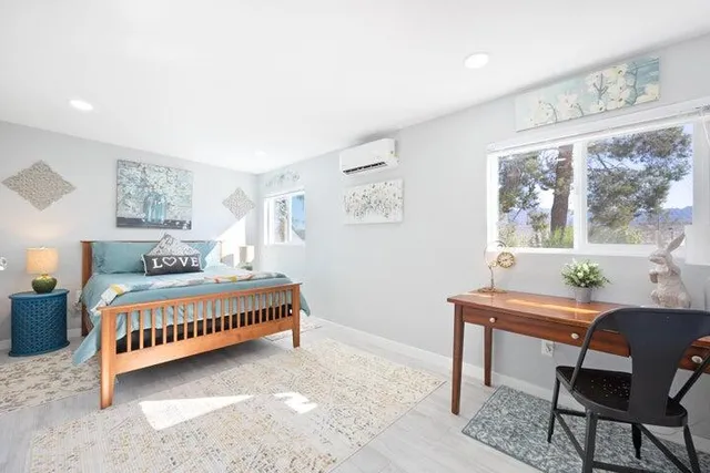 a bedroom with a bed and a window