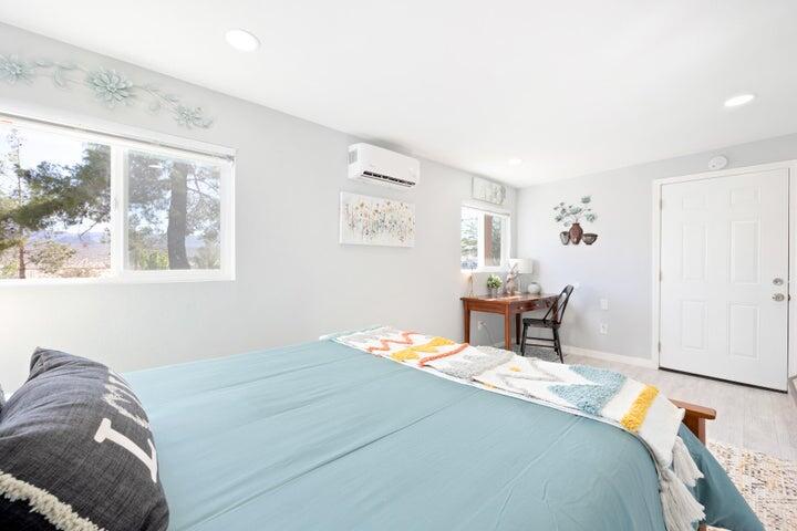 69450 Amboy Road Twentynine Palms, CA 92277 - Photo 23 of 46 a bedroom with a bed and wooden floor