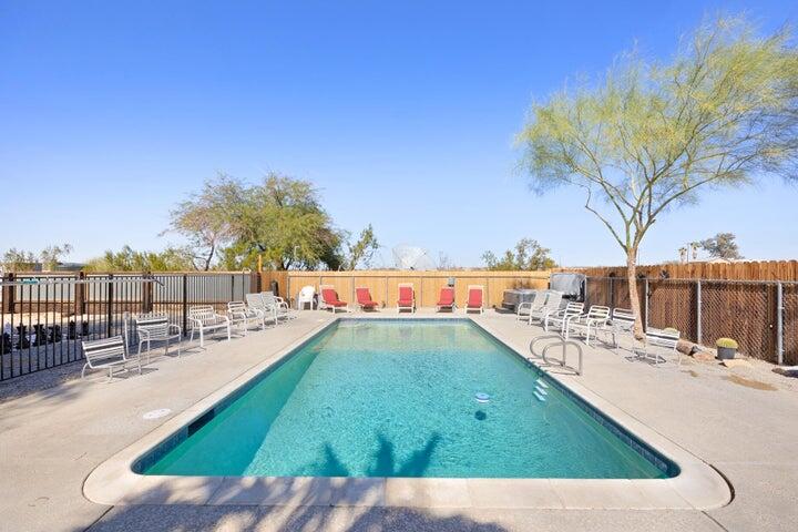 69450 Amboy Road Twentynine Palms, CA 92277 - Photo 3 of 46 a view of a swimming pool with a lounge chairs