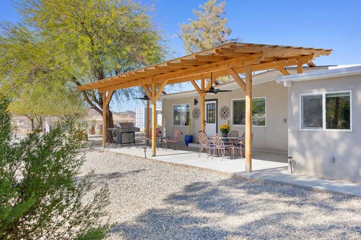 69450 Amboy Road Twentynine Palms, CA 92277 - Photo 39 of 46 a patio with a table and chairs under an umbrella