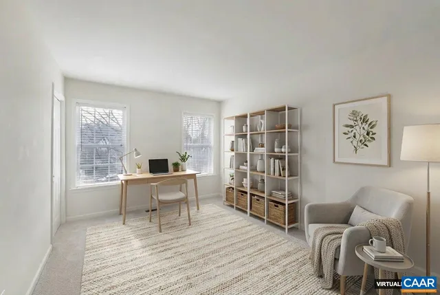 a work room with furniture wooden floor and a window