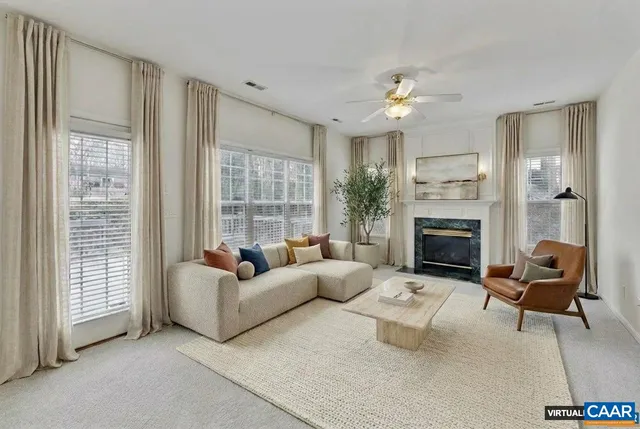 a living room with furniture and a fireplace