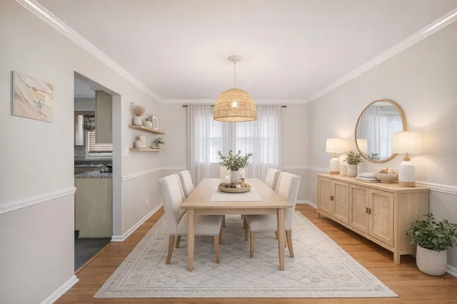 a view of a dining room with furniture and chandelier