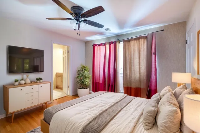 a bedroom with a bed and a flat screen tv