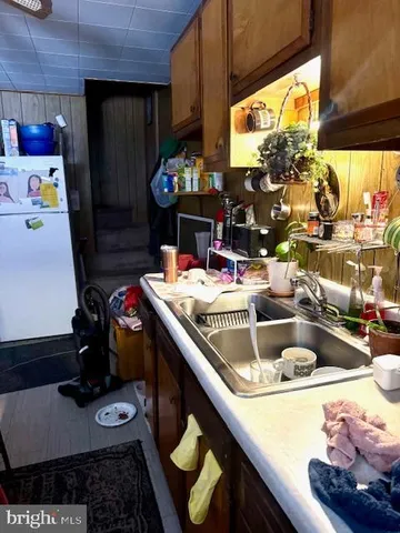 a kitchen with a sink and a refrigerator