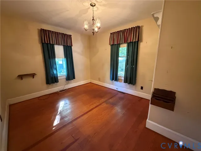 wooden floor in an empty room with windows