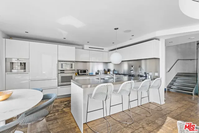 a kitchen with stainless steel appliances kitchen island granite countertop a sink and cabinets