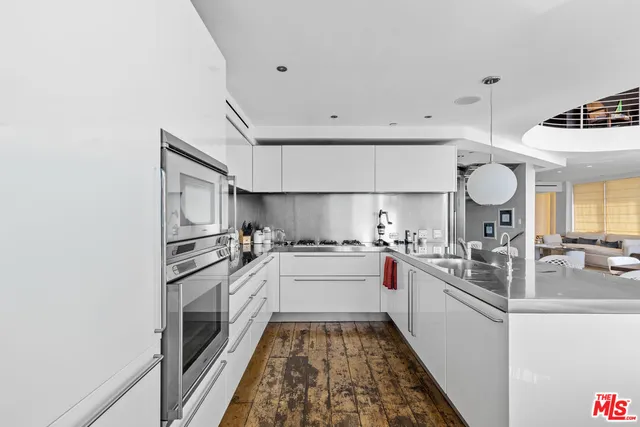 a kitchen with a sink and white cabinets