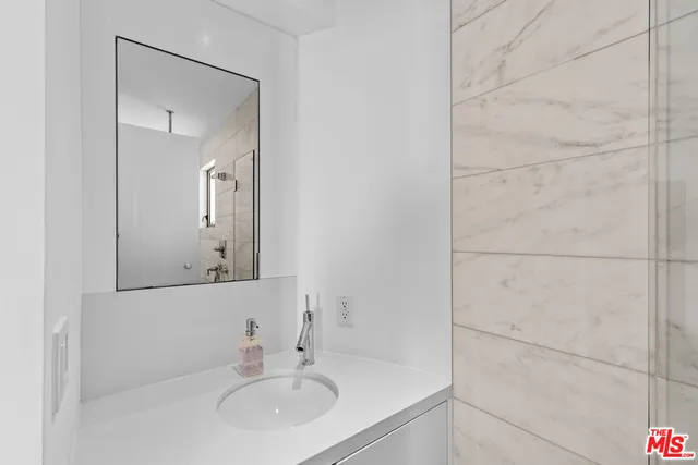 a spacious bedroom with a bed a couch and large window