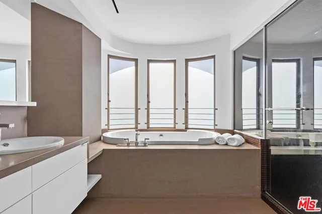 a bathroom with a sink double vanity and a mirror