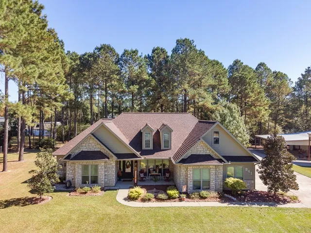 a front view of a house with swimming pool and porch