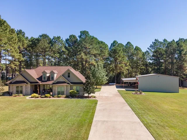 a aerial view of a house with swimming pool and sitting area