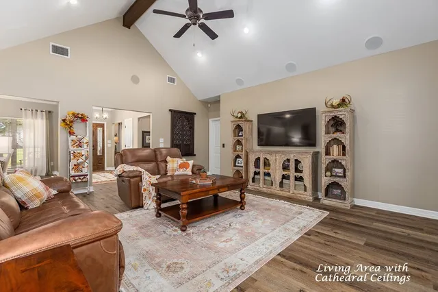 a living room with furniture and a flat screen tv