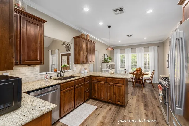 a kitchen with a sink a counter top space and appliances