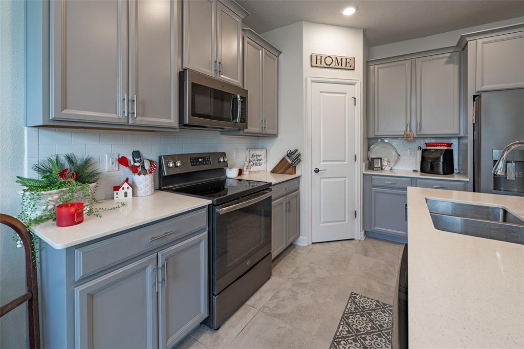 9224 Southwest 60th Ct Road Ocala, FL 34476 - Photo 9 of 55 a kitchen with stainless steel appliances granite countertop a sink dishwasher a refrigerator and a stove