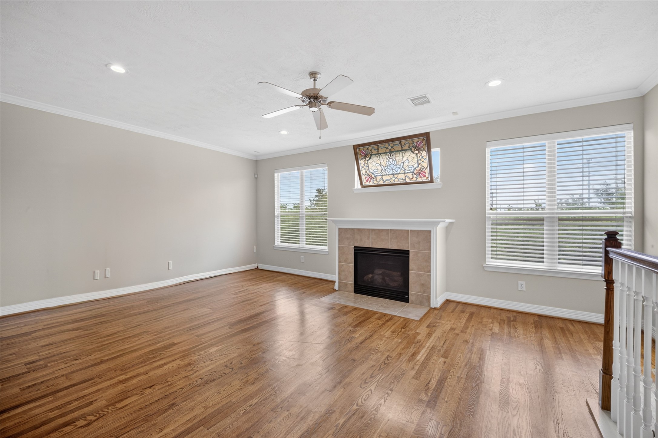 1807 Stacy Crest Houston, TX 77008 - Photo 9 of 35 a view of an empty room with wooden floor fireplace and a window