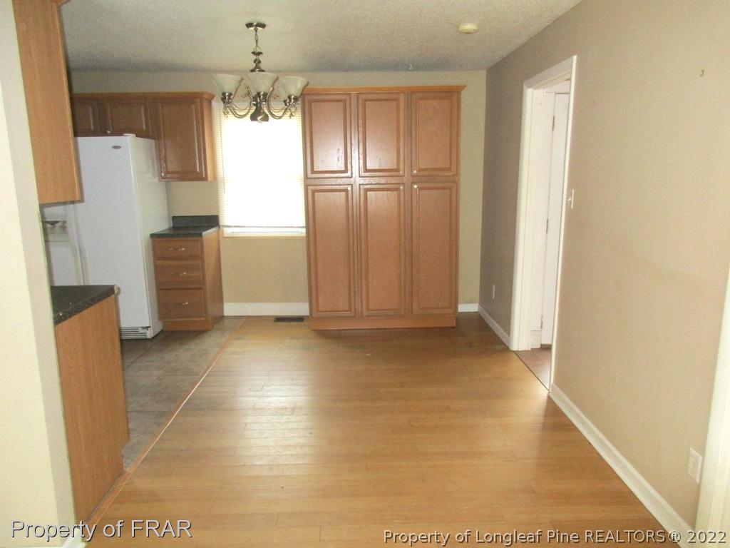2181 Tingen Road Lillington, NC 27546 - Photo 24 of 36 a view of a kitchen with a refrigerator and a window