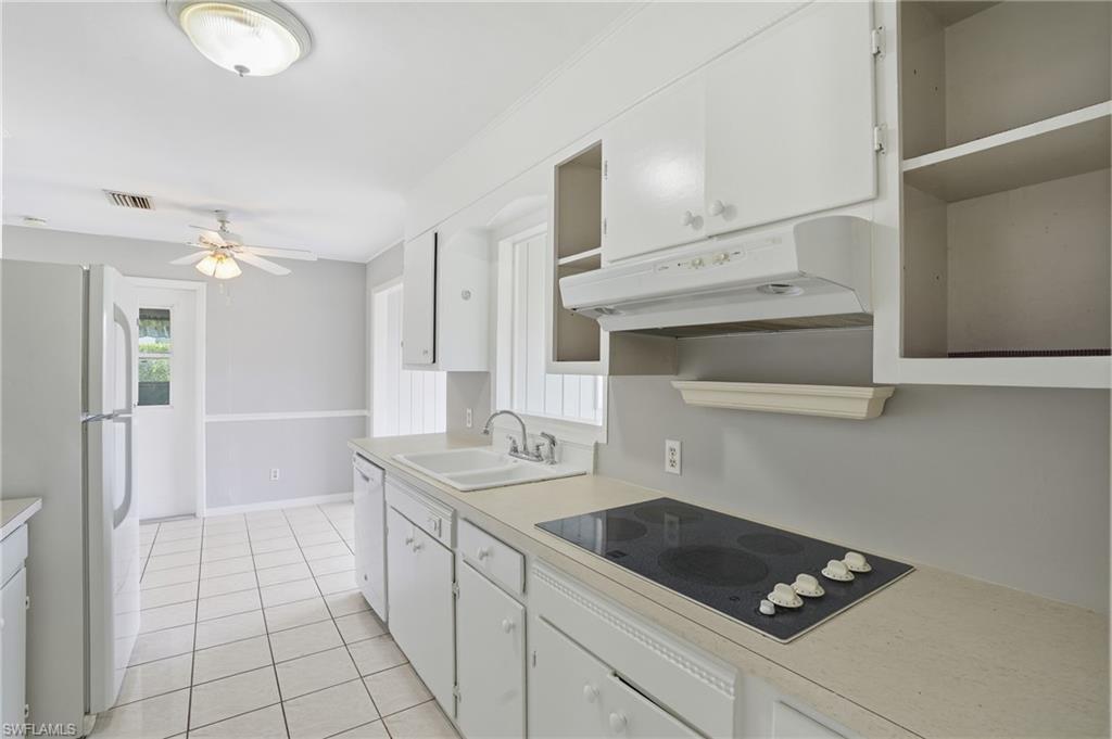 169 Viking Way Naples, FL 34110 - Photo 12 of 34 a kitchen with a sink dishwasher and cabinets