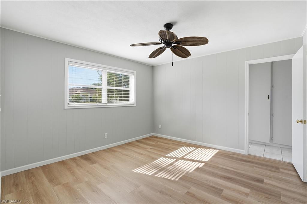169 Viking Way Naples, FL 34110 - Photo 16 of 34 a view of an empty room with wooden floor and a window