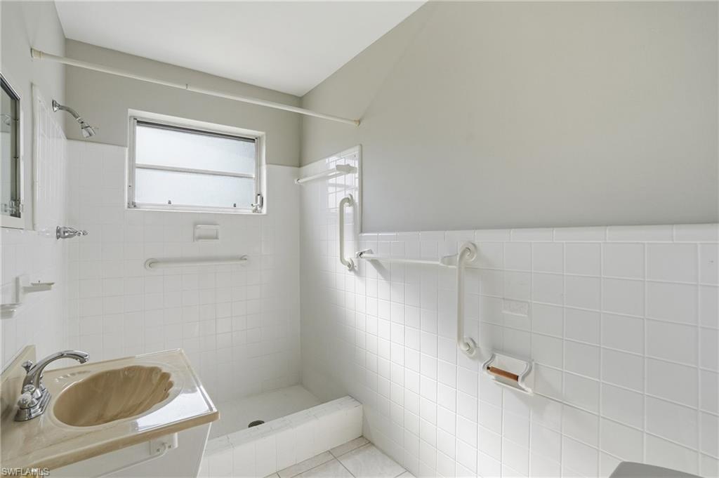 169 Viking Way Naples, FL 34110 - Photo 22 of 34 a bathroom with a sink a toilet and shower