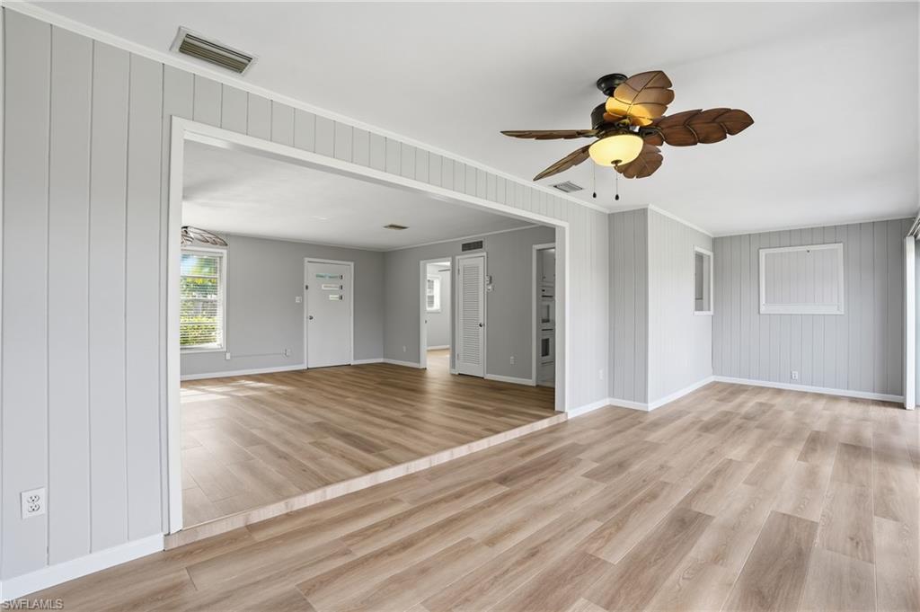 169 Viking Way Naples, FL 34110 - Photo 8 of 34 a view of an empty room and window and wooden floor