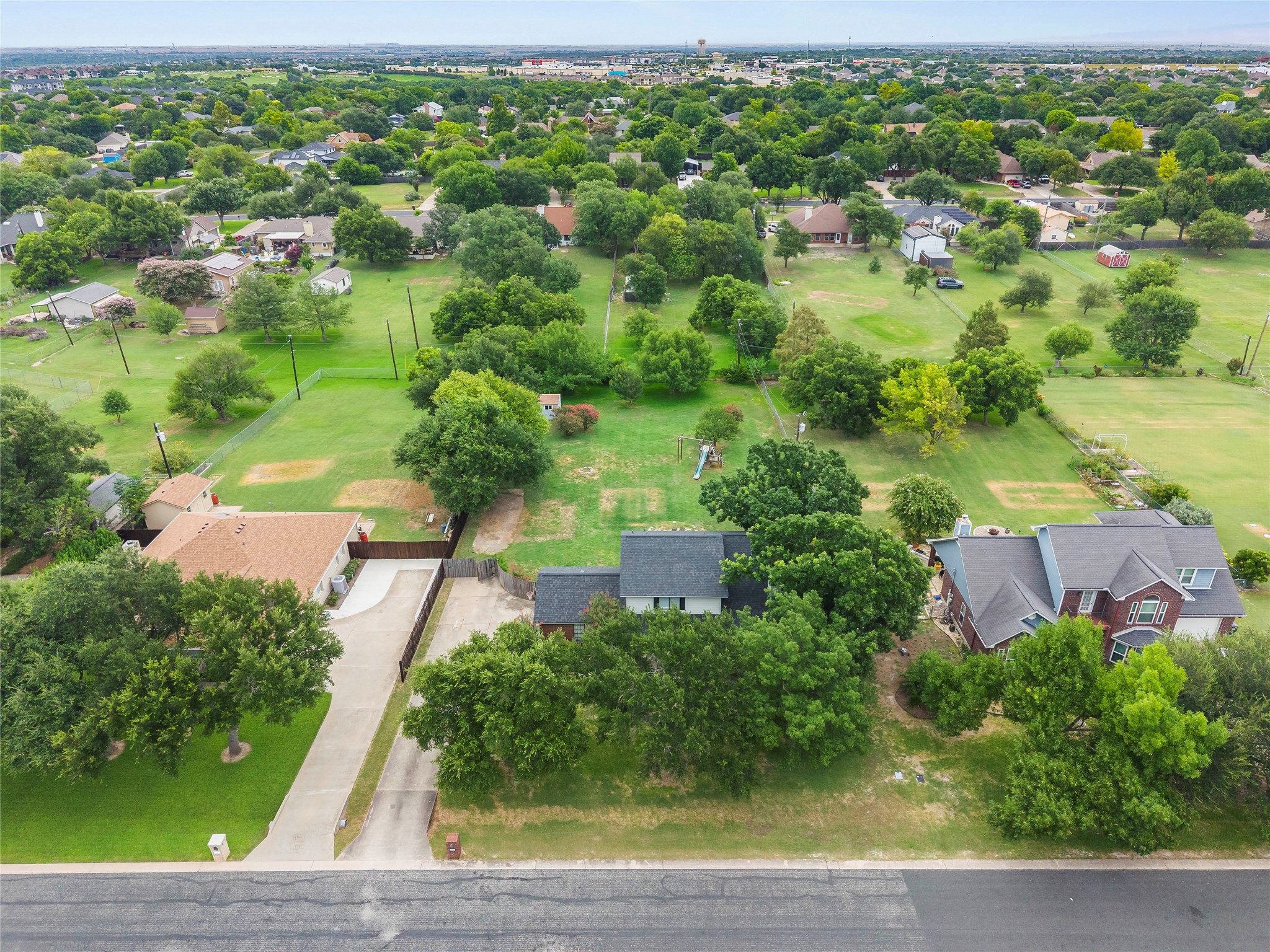1329 Quail Ravine Round Rock, TX 78664 - Photo 21 of 39 Mature trees surround this expansive suburban lot featuring plenty of green space.