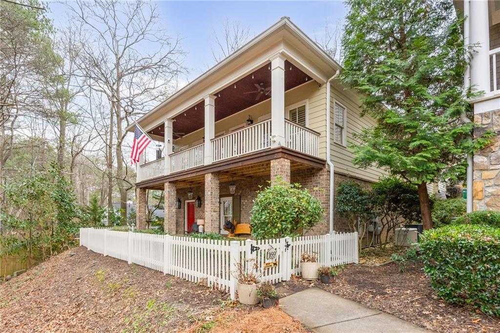 169 Hubbard Road Woodstock, GA 30188 - Photo 1 of 1 a view of a white house with large windows and flower plants